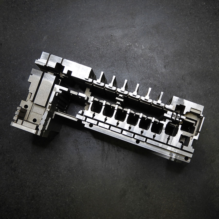 Mold part cavity for fuse box control unit made from a single block of hardened steel.